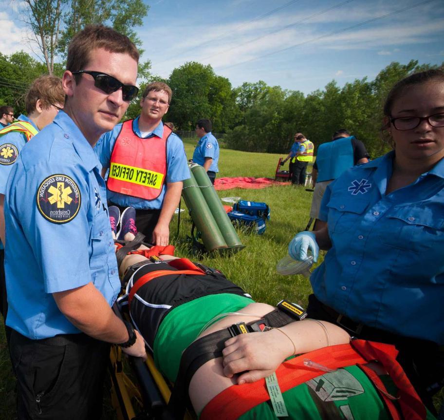 EMS students carrying patient to ambulance