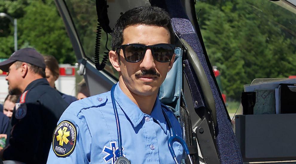 EMS student standing in front of a medical transport helicopter